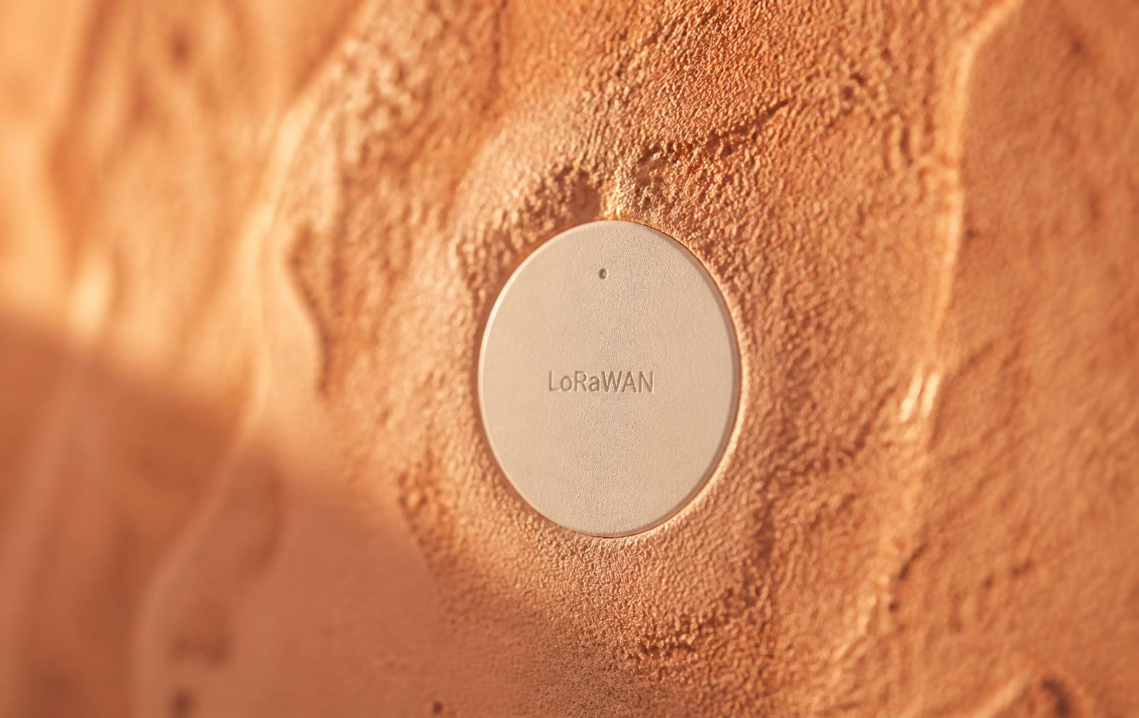 Coin-sized LoRaWAN sensor flush in a terracotta wall