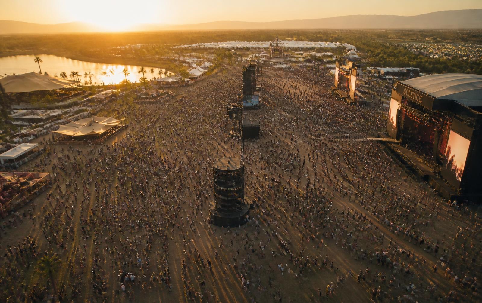 Festival crowd flowing freely at golden hour — no queues